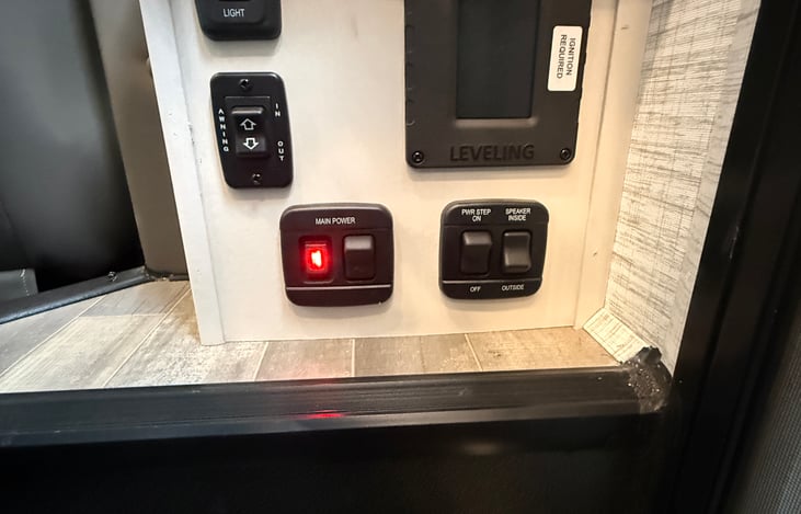 Controls  behind passenger seat beside cabin steps.