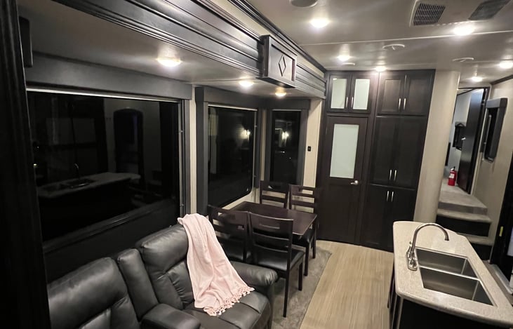 Diner table which seats four, two comfy recliners, large pantry for food storage.  Large windows for great natural lighting. Stairs to the right lead up into master bedroom / bathroom