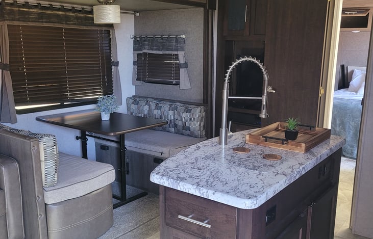 Dining table folds into bed for one adult or several kiddos. Kitchen island with double sink for extra counter space.
