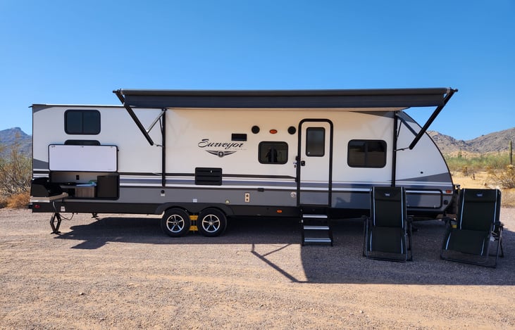 Camp side with Outdoor Kitchen and 16' awning extended. 2 reclining folding chairs for your comfort.