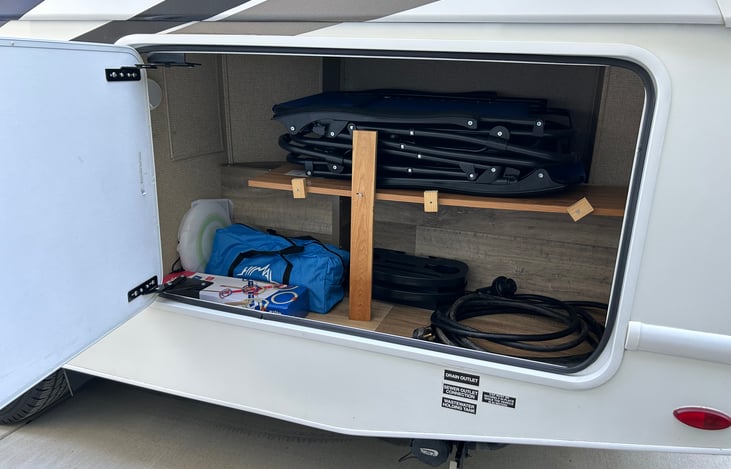 Two anti-gravity chairs. Folding table that is safe for table top grills. Cornhole, ring toss game, and frisbee.