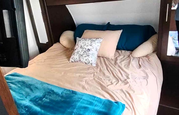 Queen bed in separate bedroom with sliding doors for privacy