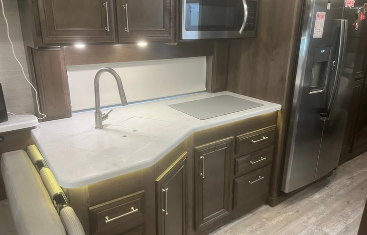 Kitchen counter with sink and stove covered.