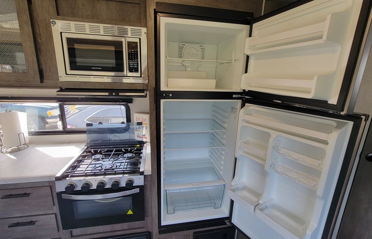 Kitchen | 3 burner stove and oven | 10.7 CU FT 12 volt Refrigerator | Microwave