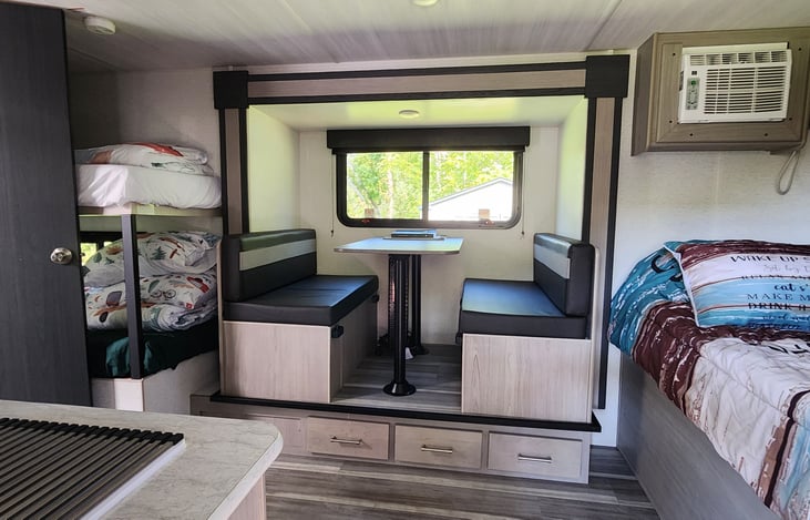 Dinette drawer 1 on the left: first aid kit, bug repellent bracelets and benadryl lotion. Drawer 2: Hatchet, saw, knife, lighter. Drawer 3: Inspection sheet, level system, fuses, teflon tape.