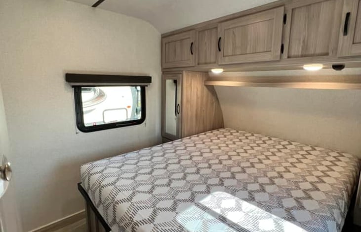 The queen-sized bed has an upgraded mattress for comfort during your stay. Lots of storage space is available, including a shelf over your head with touch lights. A smart TV is also installed.