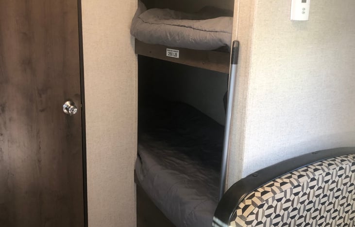 Bunk beds (weight capacity of 250 lbs each bed), door to bathroom
