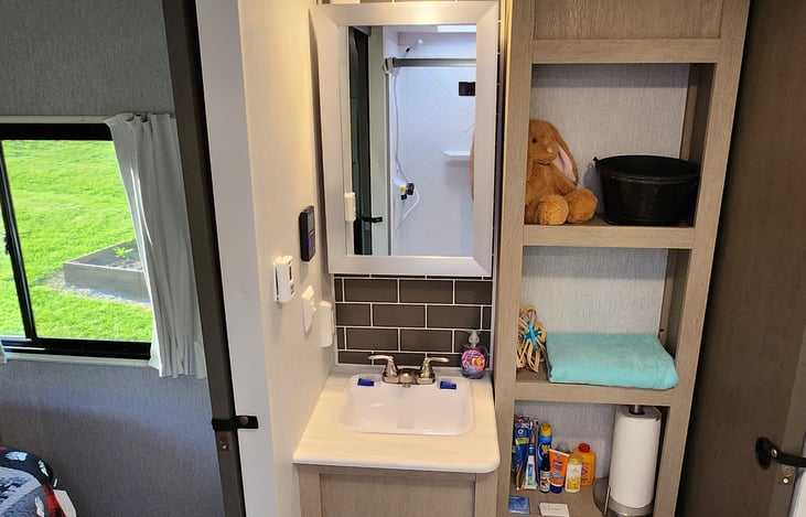 Bathroom includes its own sink, medicine cabinet, towels, and all essentials.