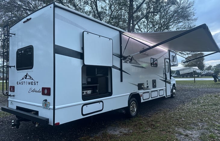 Outdoor Kitchen, LED Light Awning, and trailer hitch shown in photo.