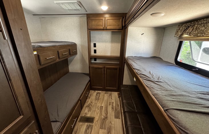 Bunk room with three twin beds and a couch that turns into a bed