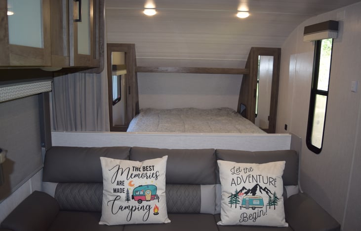 View of the queen size bed as well closet space on both sides.