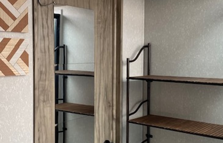 Full length mirror adjacent to amenity shelf