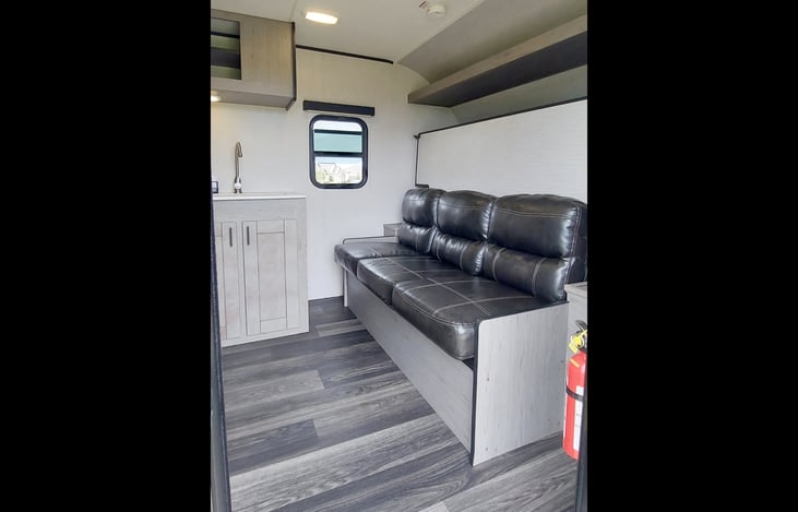 Fold down sofa / queen size Murphy bed with overhead storage. Operable side window for cross-ventilation.