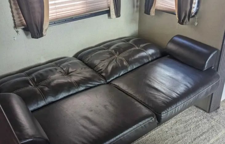 Sofa conversion to bed with storage underneath with linens