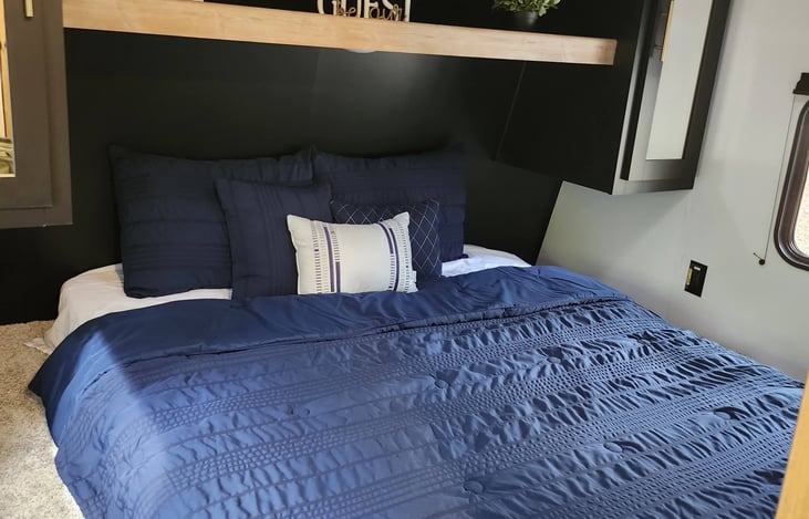 Master Bedroom- Queen Bed with an UPGRADED 10" Memory Foam Mattress for a comfortable night's sleep, bedside outlets, 24" Smart TV, double shelves with dual wardrobe storage.