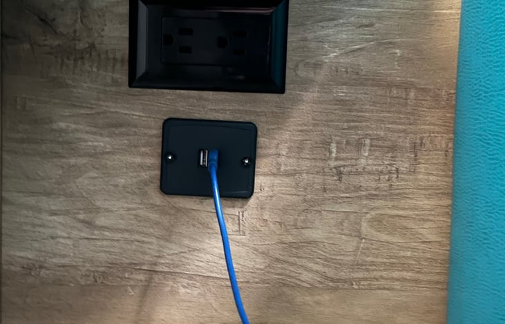 110v receptacle and USB port next to Queen size Murphy bed