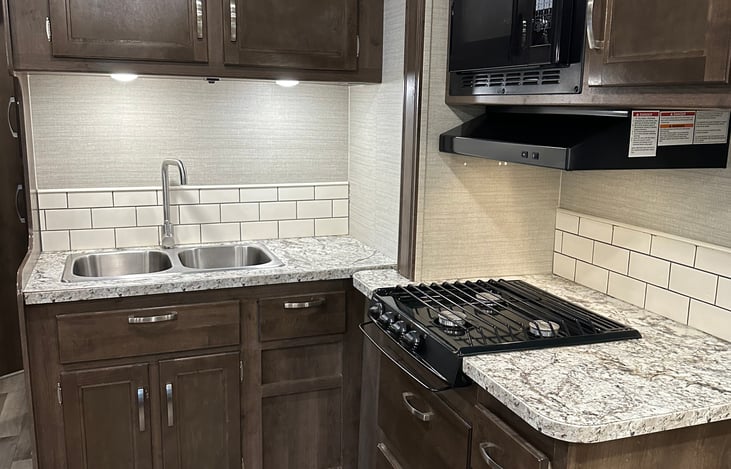 microwave and stove top in kitchen