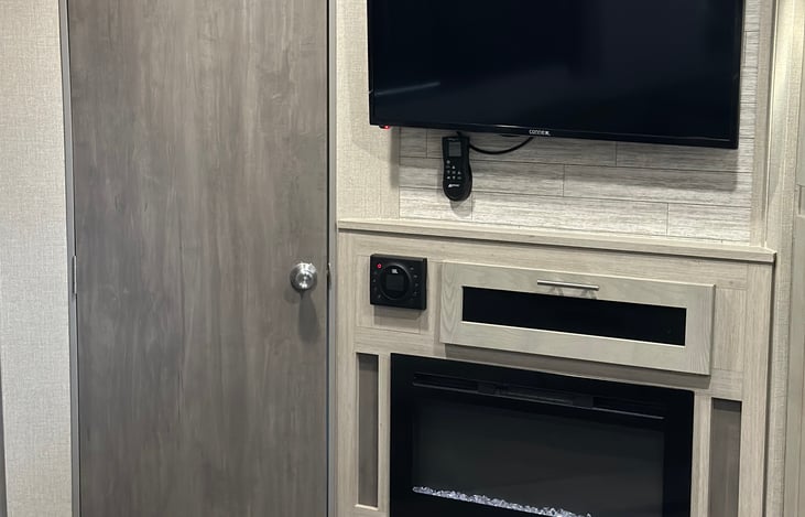 TV, fireplace, and JBL speakers