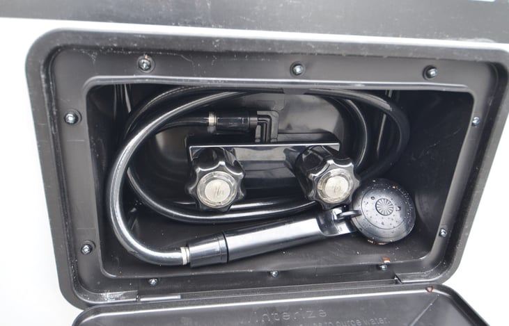Outdoor shower with hot and cold water for washing off sandy feet from the beach.