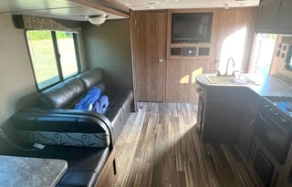 Camper with a queen living space and a bunkhouse.