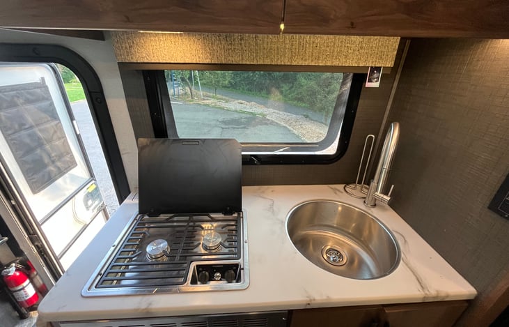 Propane burner with an extendable cutting board to the left  (not extended in the picture). The cutting board adds on an additional 2 feet of counter space