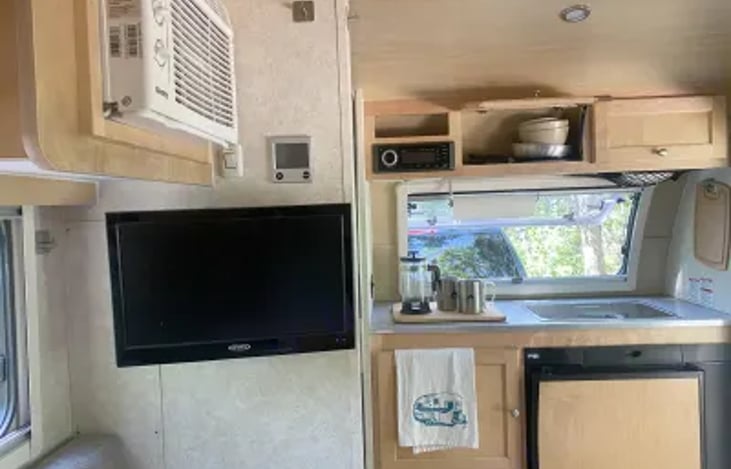 Covered countertop, refrigerator, storage space, TV with HDMI hookup and DVD player (select DVD's provided), air conditioner, furnace control.