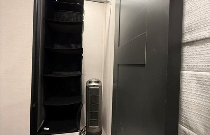 Master Bedroom Closet. Incudes hanging storage and space heater.
