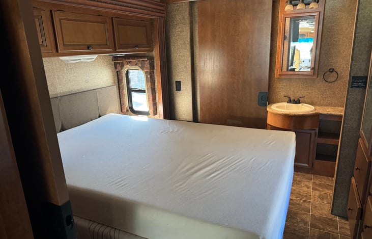 Master bedroom and private bathroom and shower with slide extended. Queen size bed! Lots of storage area for clothing including hanger racks