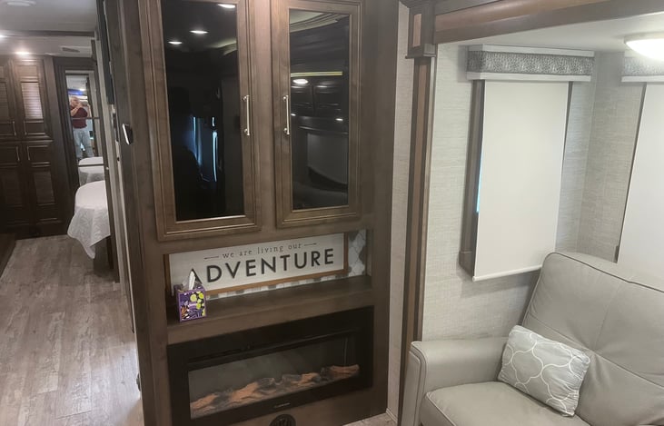 Hutch above electric fireplace.