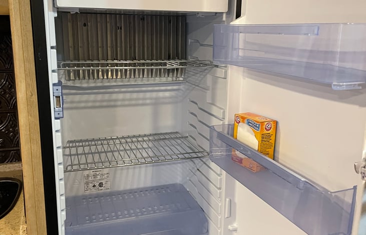 Large fridge with dedicated freezer works on shore power, batteries, or propane.