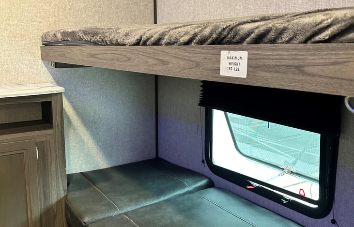 Bunk house table and chairs converts to twin bunk, and top bunk comes down