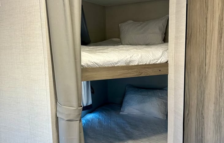 Let your kids (or adult friends) debate who gets the top and bottom bunks!  Includes a curtain at the opening for extra privacy for your guests.