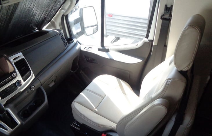 The front passenger seat that can also swivel to face the kitchen when the RV is parked.