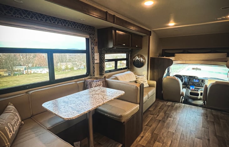 large u shaped dinette, love seat and cab view from door to bedroom