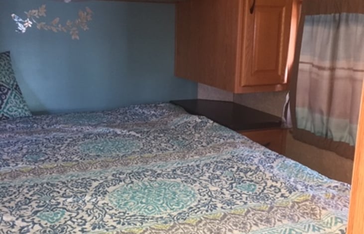 Master bedroom with linens driver side