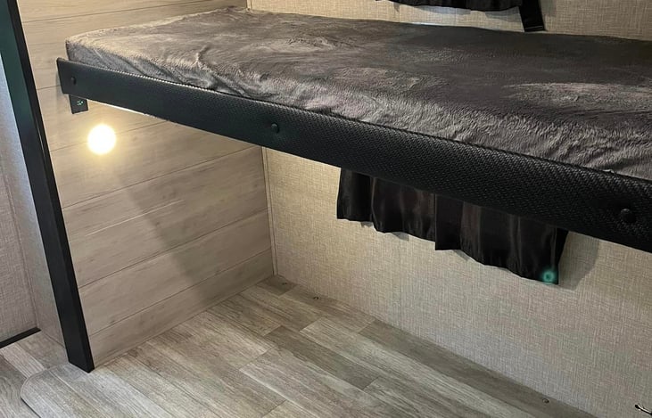 Bunk house top twin bed. Can be stowed away to create more space.