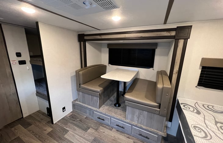 Dinette with view of 2 twin bunks and bathroom door