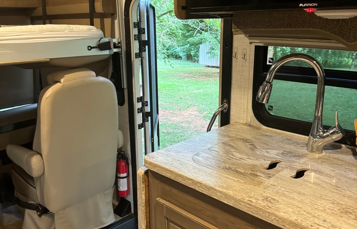 Coach door to outside with screen door and motorized steps.