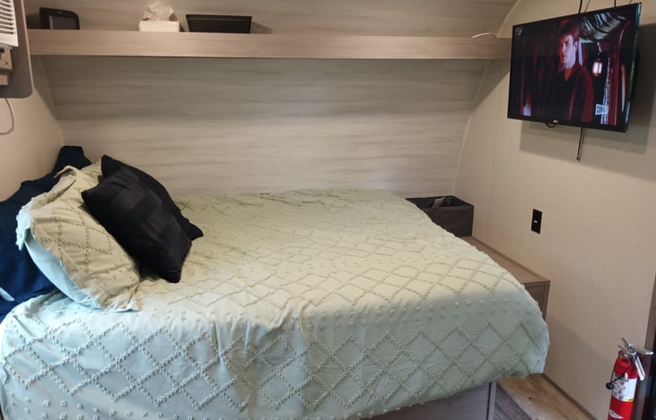 An upgraded mattress, which is super comfy! Sheets, duvet, throw pillows and four bed pillows included. TV swivels and works while boondocking, super convenient.