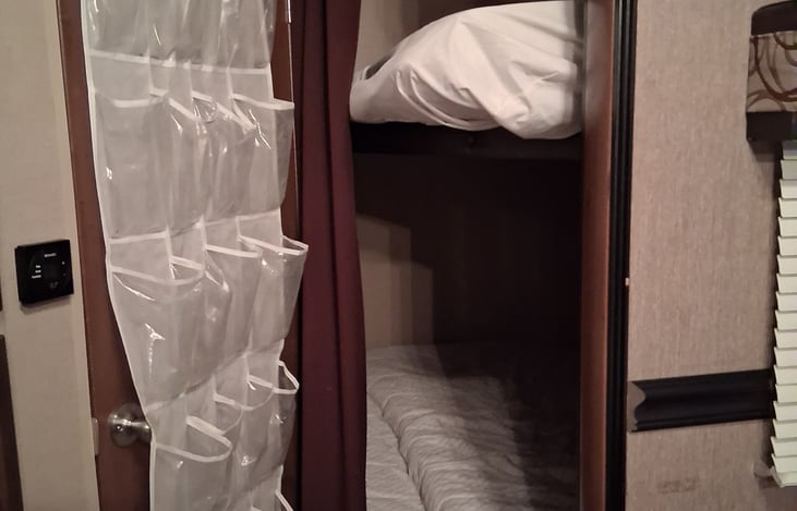 Full size top/bottom bunks with privacy curtain. Can fit up to 2 people each. Storage unit under bunk beds.