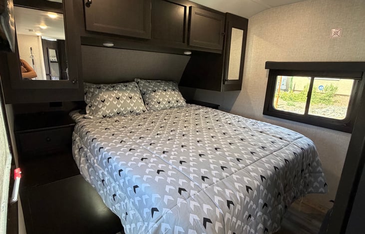 Private master bedroom with a barn door. Plenty of storage surrounds the queen size mattress. Vacuum located in this room.
