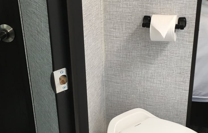 The master bathroom with RV-safe toilet paper leads to the master bedroom, via a pocket door or a full-sized door to the living room.