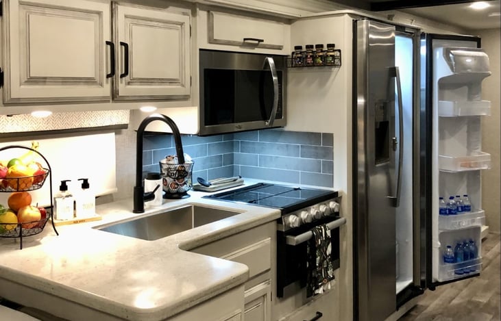 Kitchen with full size, 15 cubic ft. refrigerator and freezer with ice maker.
