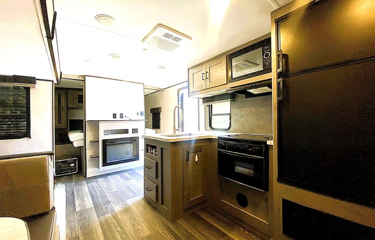 Full kitchen view with generous storage — cook fresh meals after a day exploring El Capitan State Beach, Vidal Junction, or Mountain and River Adventures in Kernville.