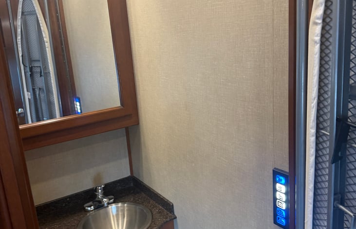 Ironing board is located on half bath door