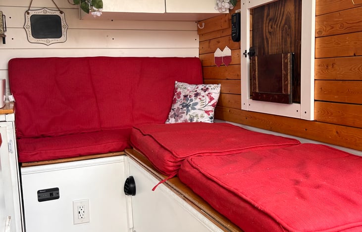 This is the bed in its L shaped form. Right next to the partition wall that separates the cockpit. We are looking through the sliding door.