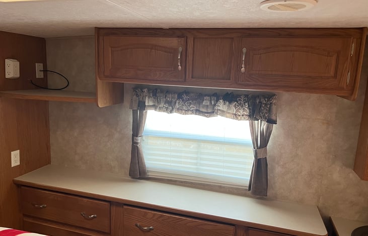 Dresser and cabinets at the foot of the master bed.