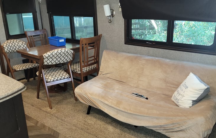 The futon in the living area folds out to a bed.  The cover is washed between each use. The kitchen table extends.