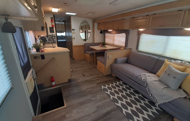 The custom upholstered dinette cushions, jack knife couch and window valances are a soft grey color, we are very pleased with how they all turned out!