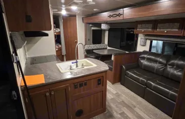 Spacious interior includes a dining area and sofa that converts into a bed.